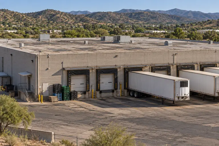 Cold storage warehouse with dock doors and refrigerated trailers north of Nogales