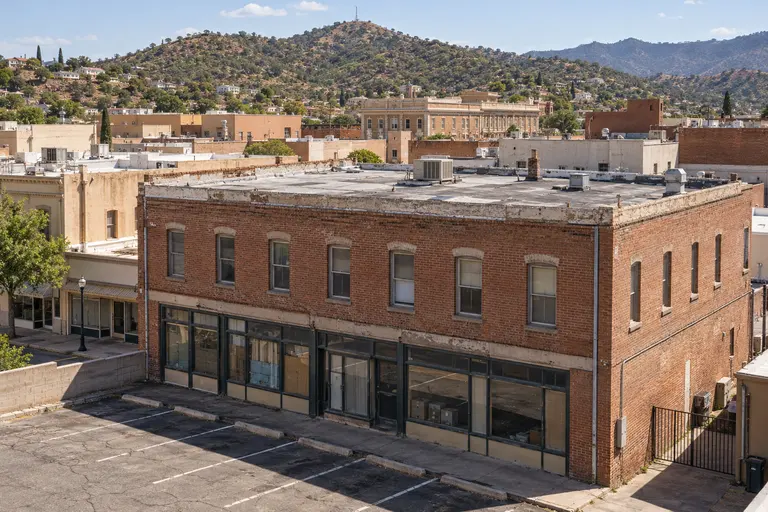 Two-story brick downtown storefront building with a flat roof